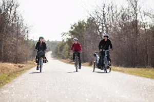 Midadult Men Prints: Full length of family riding bicycles on country road against sky
