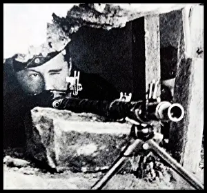 Belgium Prints: Leon Degrelle (15th June 1906 - 31st March 1994) is shown aiming down the ironsights of the MG 34