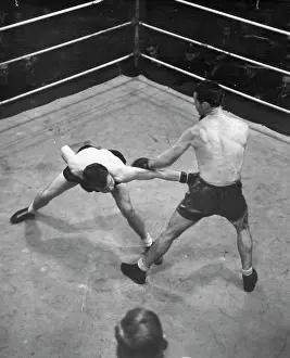 Boxer Prints: Les Sloane knocks down a long left by Sel Hamilton during their fight at the Stadium last night