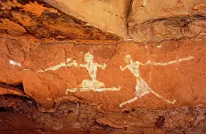 North Africa Prints: Libya, Fezzan, Jebel Akakus. A pair of running figures painted onto the walls of Uan Muhuggiag