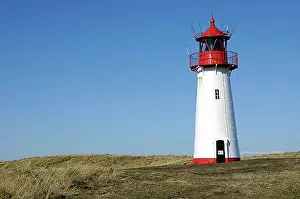 Orientation Prints: Lighthouse painted red a white standing on grassy hill