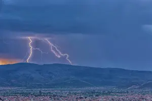 Flash Prints: Lightning during a thunderstorm at sunset over the city of Cochabamba, Bolivia