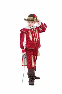 Manly Prints: Little boy posing in musketeer suit Little boy posing in red musketeer suit with sword