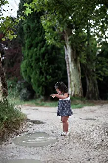 Puddle Prints: A little girl playing in a puddle