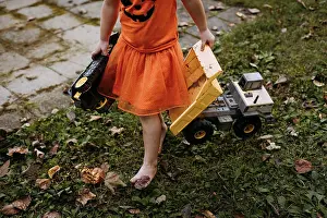3 4 Years Prints: Little girl playing with toy trucks and tractors during autumn