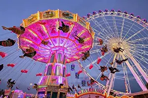 Luminous Prints: A lively funfair at dusk, illuminated by a large Ferris wheel and a colourful chain carousel