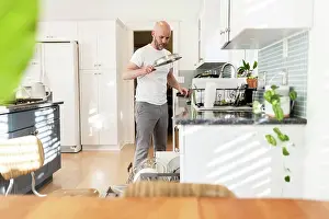 Family Life Prints: Loading dishes in a sunny white kitchen