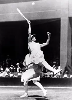 Team Work Prints: London, England: 1928 Kea Bouman of the Netherlands leaps high to try to return a high ball in the Doubles