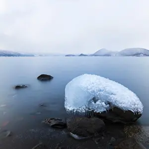 Balance Prints: Long exposure shot of rock covered in ice at lake Toya, Hokkaido, Japan