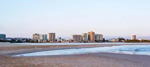 Pure Prints: Looking across beach at low tide and early morning to Maroochydore township and high rise buildings