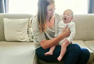 Yawn Prints: Love, security or yawn with mother and baby on sofa in living room of home together for bonding