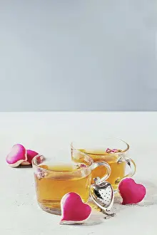 Beverage Prints: Love Valentines day greeting card with two glasses of hot tea and heart shape homemade cookies with pink icing