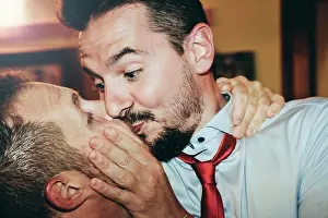 Gender Prints: Loving gay couple kissing passionately at the wedding party - Two handsome men having romantic kiss indoors - LGBT