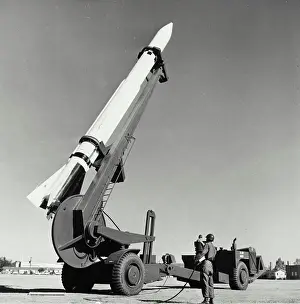 Unrecognisable Prints: Low angle view of an army soldier standing near a missile