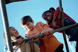Overalls Prints: Low angle view of three children playing on a monkey bars