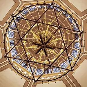Glass Material Prints: Low Angle View Of A Dome Ceiling Through A Hanging Chandelier In A Star Of David Shape In The Neve Salom Synagogue