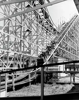 Large Group Of People Prints: Low angle view of a group of people riding on a roller coaster