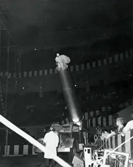 Circus Prints: Low angle view of a human cannonball at the circus