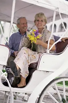 Wagon Prints: Low angle view of a senior couple in a carriage
