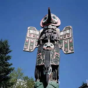Wing Prints: Low angle view of Sun Raven totem pole, Saxman Totem Park, Ketchikan, Alaska, USA
