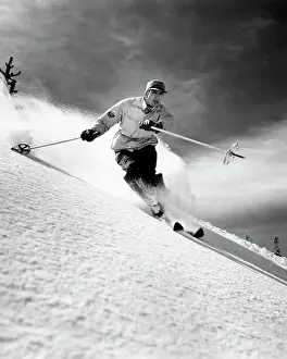 Covering Prints: Low angle view of a young man skiing downhill