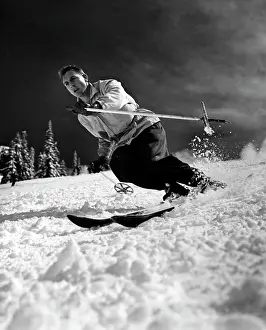 Covering Prints: Low angle view of a young man skiing downhill