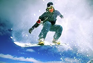 Sseditor Aa Prints: Low angle view of a young man snowboarding