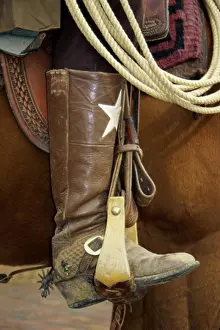 Leather Prints: Low section view of a cowboy riding a horse
