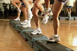 Standing On One Leg Prints: Low section view of a group of people exercising in a step aerobics class