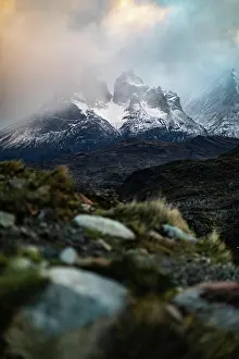 Calm Prints: Magnificent landscape of wild highland against snowy mountains ridges at horizon among lush dramatic clouds