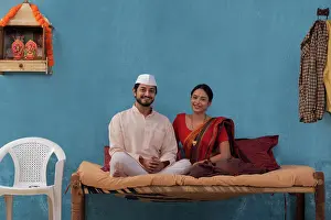 Nose Piercing Prints: Maharashtrian couple sitting together on cot at home