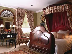 Curtain Prints: Mahogany half-tester bed in townhouse bedroom with large mirror above dressing table