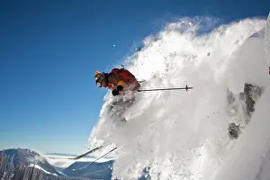 Gear Prints: A male backcountry skier drops a cliff while out ski touring