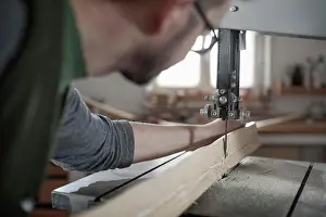 Work Tool Prints: Male bow maker sawing wood with a bandsaw, Bavaria, Germany