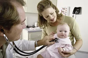 Sseditor Aa Prints: Male doctor examining a baby girl