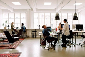 Business And Occupation Prints: Male and female business colleagues working in creative workplace