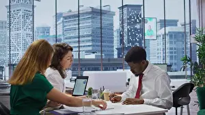Recruitment Prints: Male job candidate filling in his application form in high end office