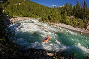 Difficult Prints: Male kayaker rides the fun waves trains of the White River