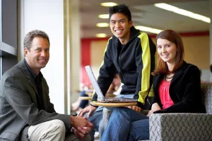 Professor Prints: Male professor sitting with his students and smiling