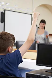 School Children Prints: Male Pupil Answering Question In School Classroom