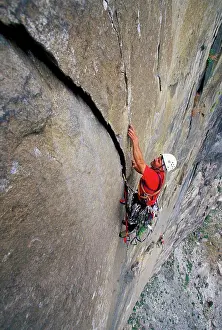 Difficult Prints: A male rock climber aid climbing on a big granite wall in Yosemite National Park