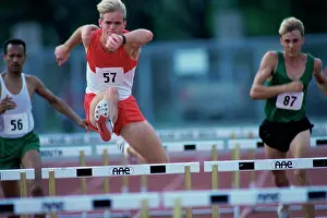 Agility Prints: Male runners jumping hurdles in a race