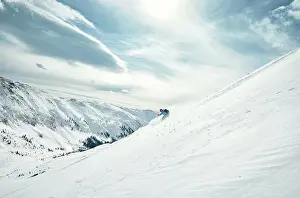 Mountain Prints: Male skier skis down a powdery slope on a sunny day in Colorado