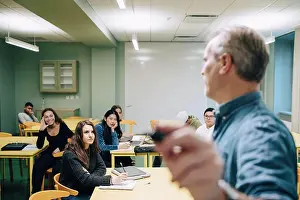 Communications Prints: Male teacher teaching high school students in classroom
