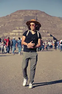Late Twenties Prints: Male wearing sunglasses and hat, walking around Teotihuacan