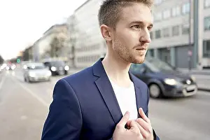 Communications Prints: Man in a blue blazer on a city street