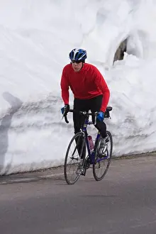 Bicycle Prints: A man climbing uphill on a bicyle in winter on Donner Summit in California