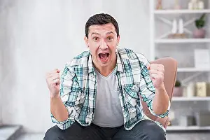 Pointing Prints: Man crying showing fists chair home