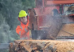 Cutting Prints: Man cutting up a large red pine log with a portable sawmill