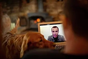 Video Prints: Man with dog video chatting with colleague on laptop screen